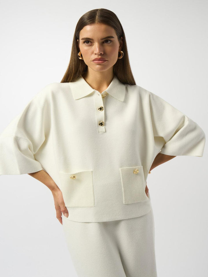 Woman wearing a cream-colored outfit with a white background