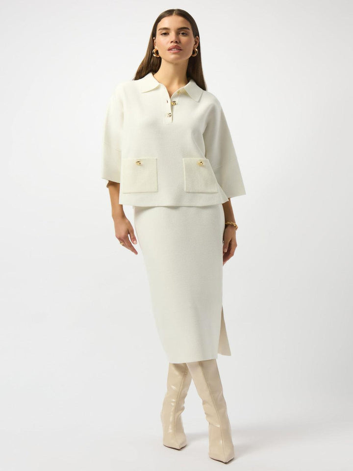 Woman wearing a cream-colored suit with a white background