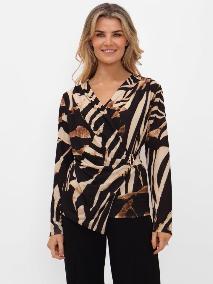 Woman wearing a zebra print top on a white background
