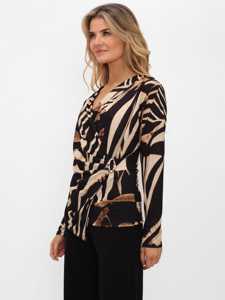 Woman wearing a zebra print top on a white background