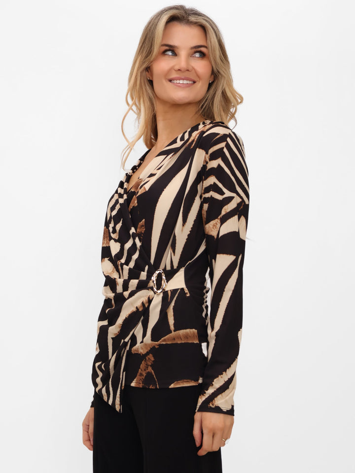 Woman wearing a zebra print top on a white background