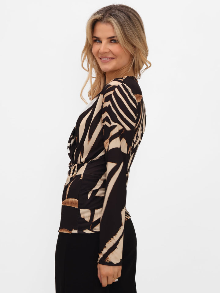 Woman wearing a zebra print top on a white background