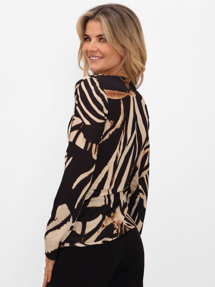 Woman wearing a zebra print jacket on a white background