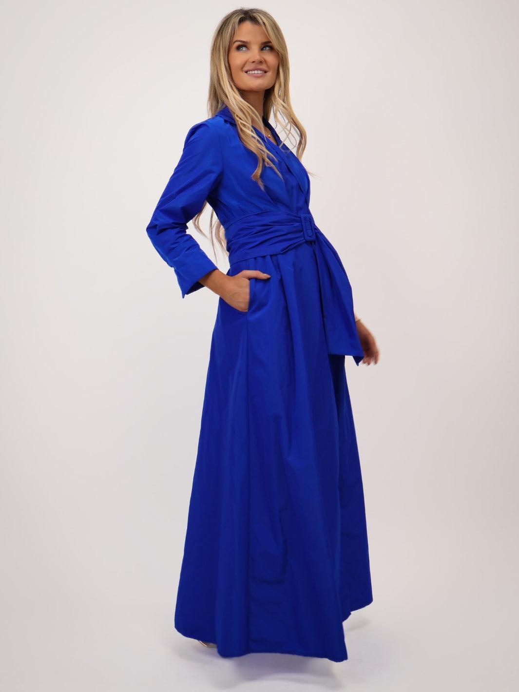 Woman wearing a blue dress against a white background