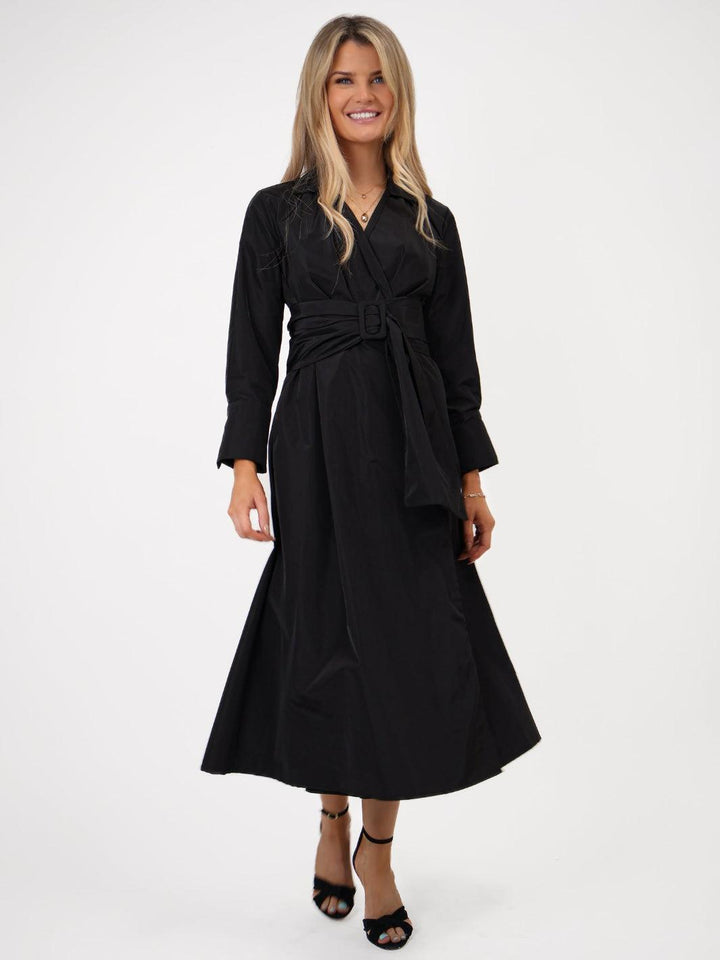 Woman wearing a black dress on a white background