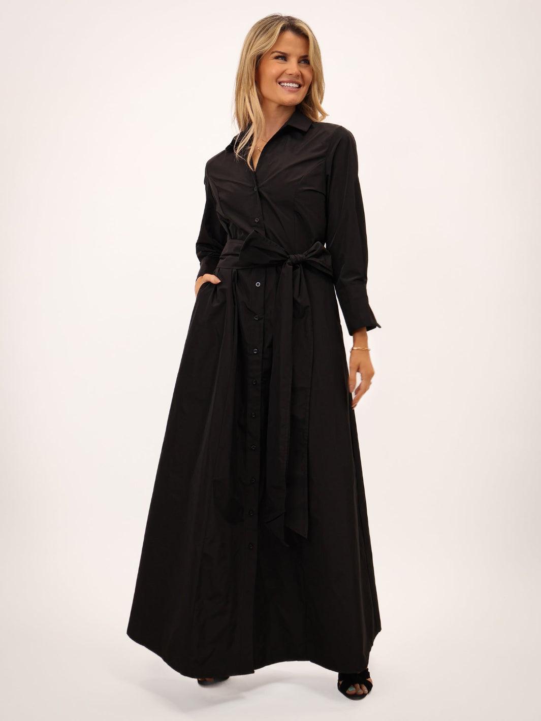 Woman wearing a black long dress on a white background