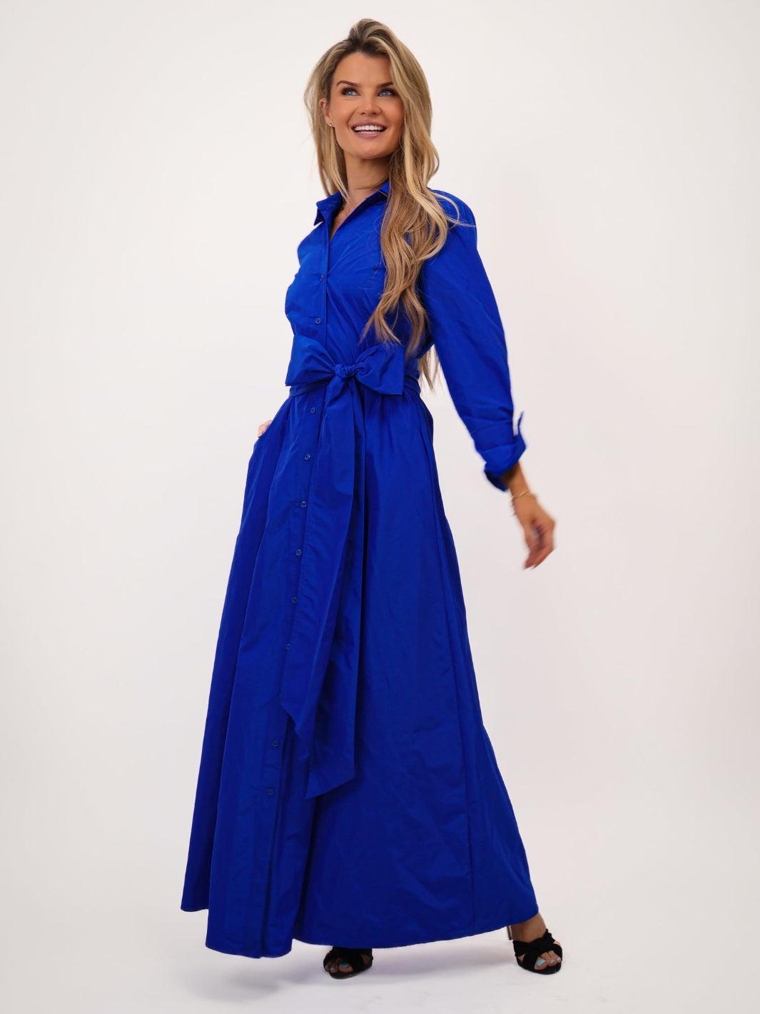 Woman wearing a blue dress on a white background