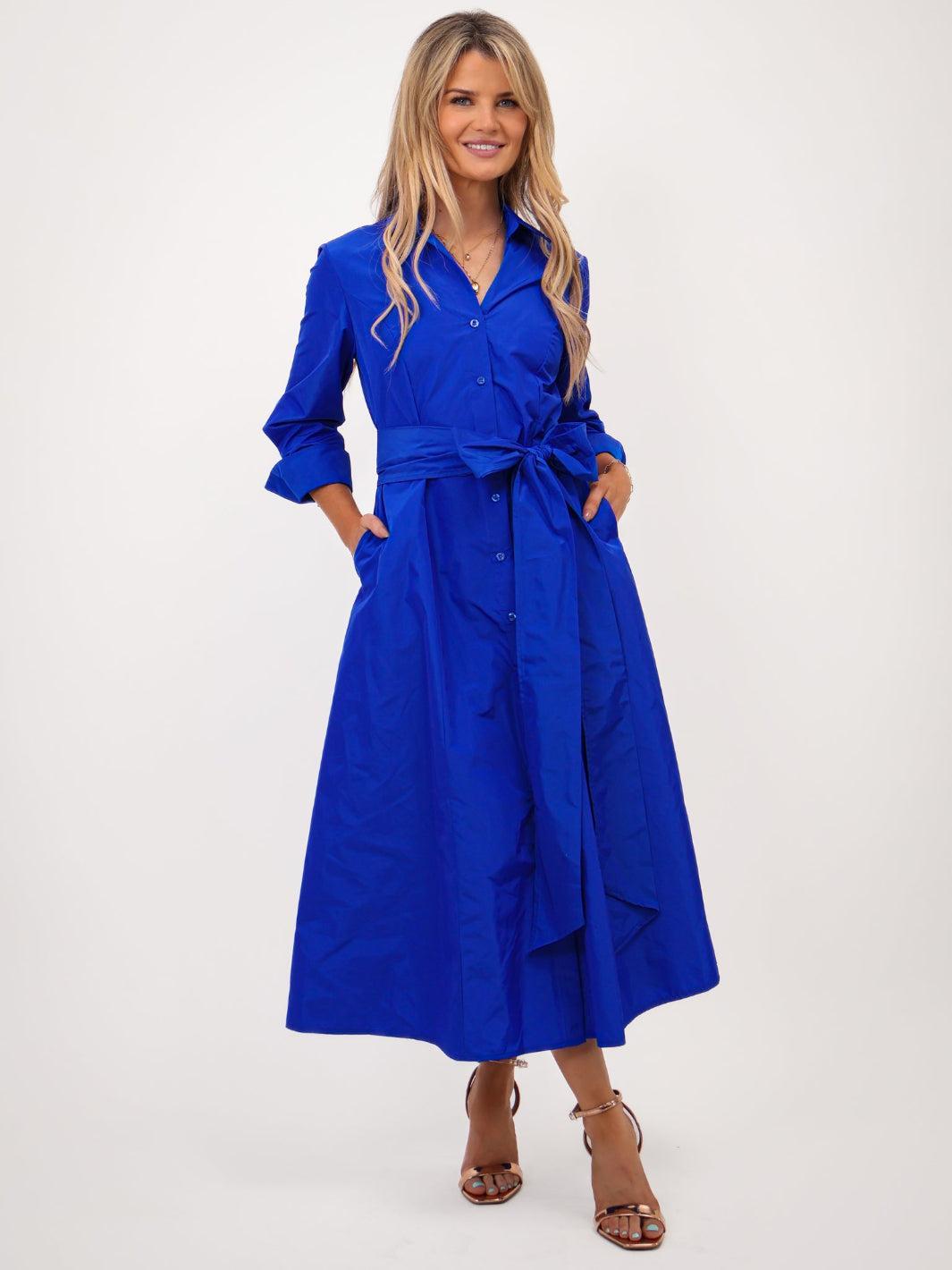 Woman wearing a blue dress with a white background