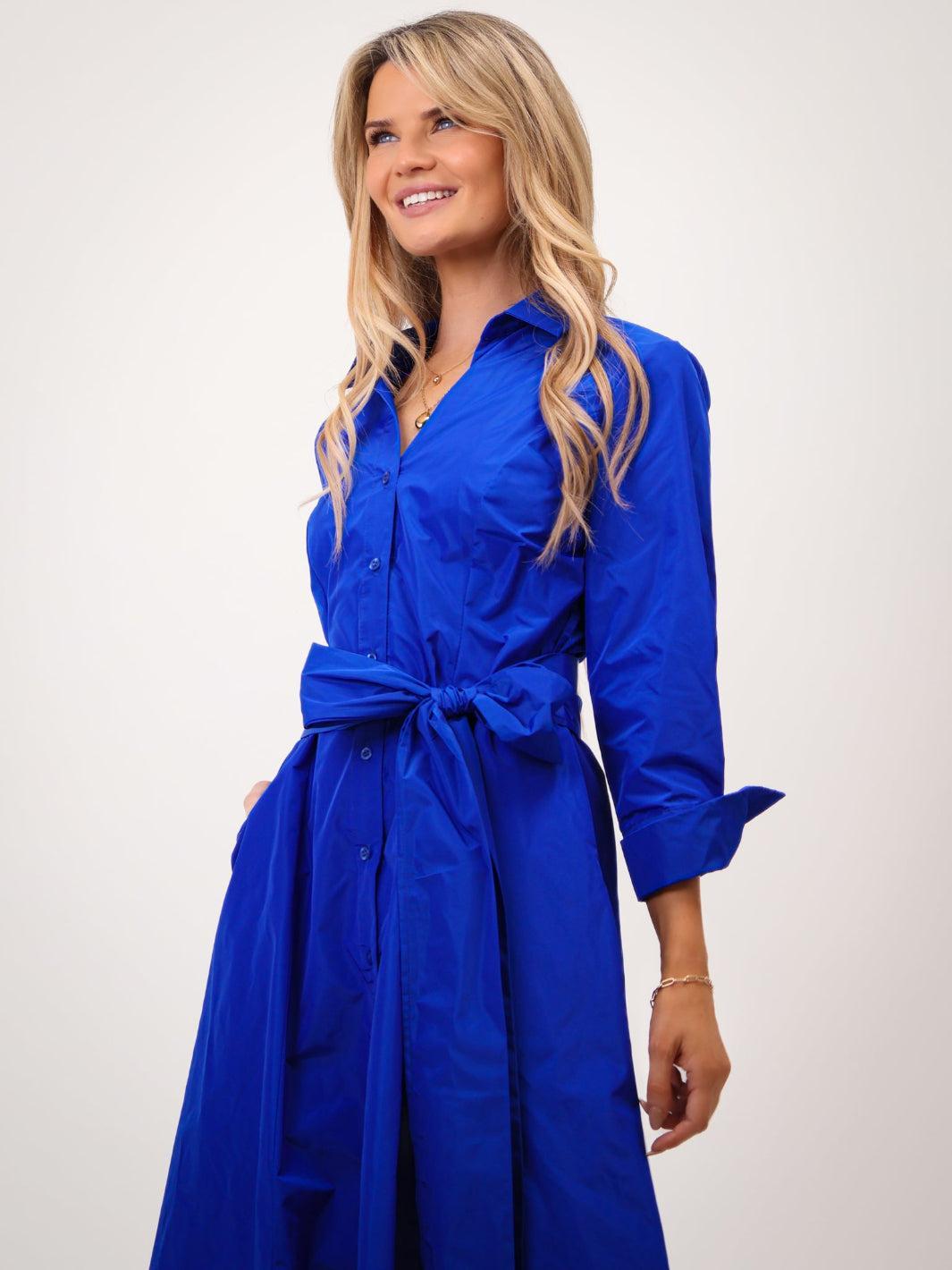 Woman wearing a blue dress with a white background