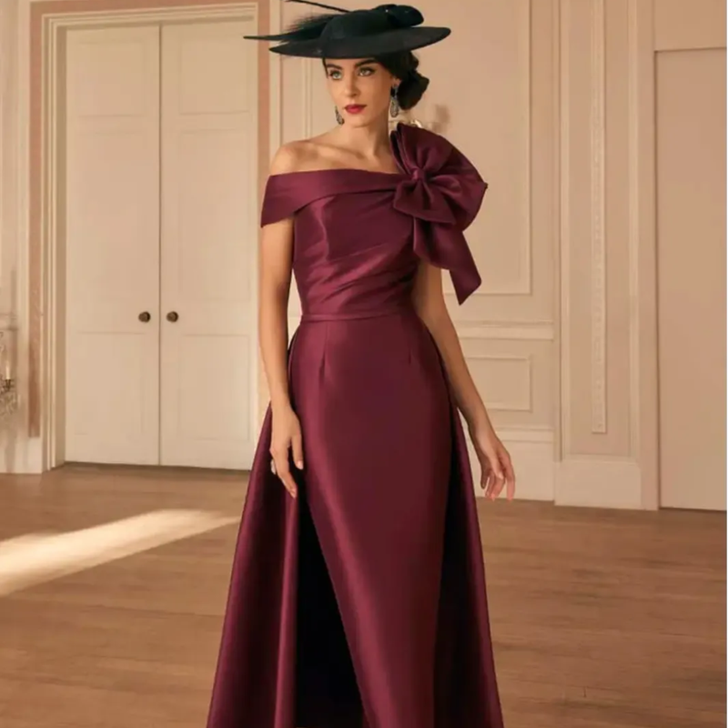 Burgundy off-the-shoulder gown with bow detail and hat