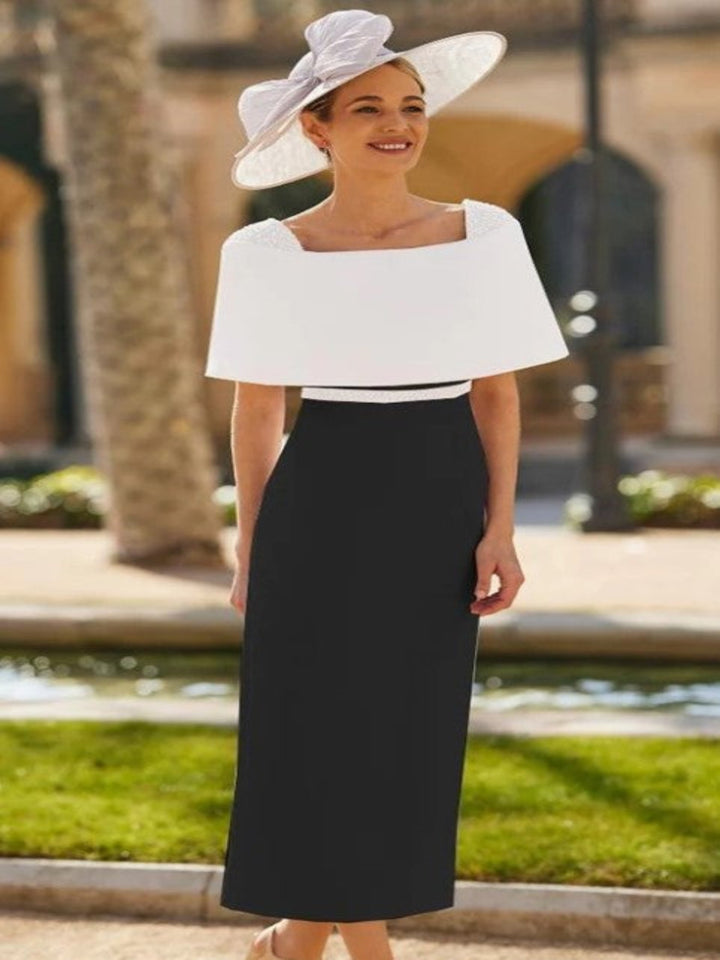 Woman wearing a white top and black skirt with a decorative hat outdoors.
