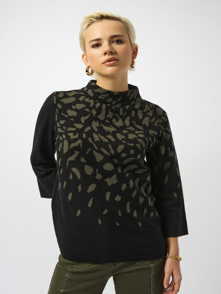 Woman wearing a black turtleneck with a patterned overlay on a white background
