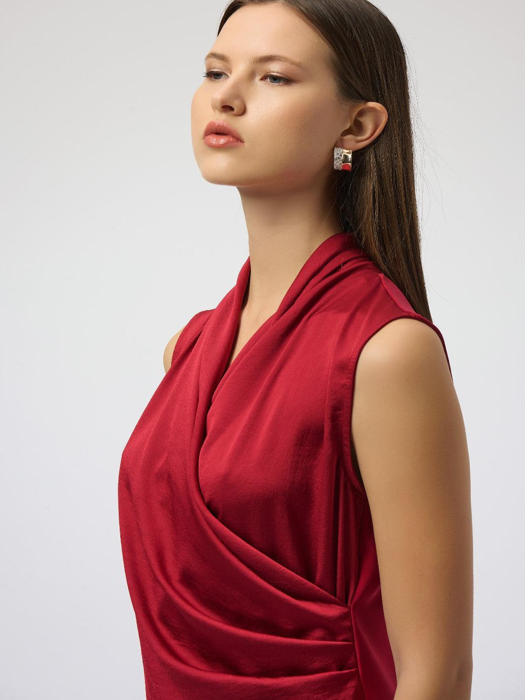 Woman wearing a red sleeveless top against a white background