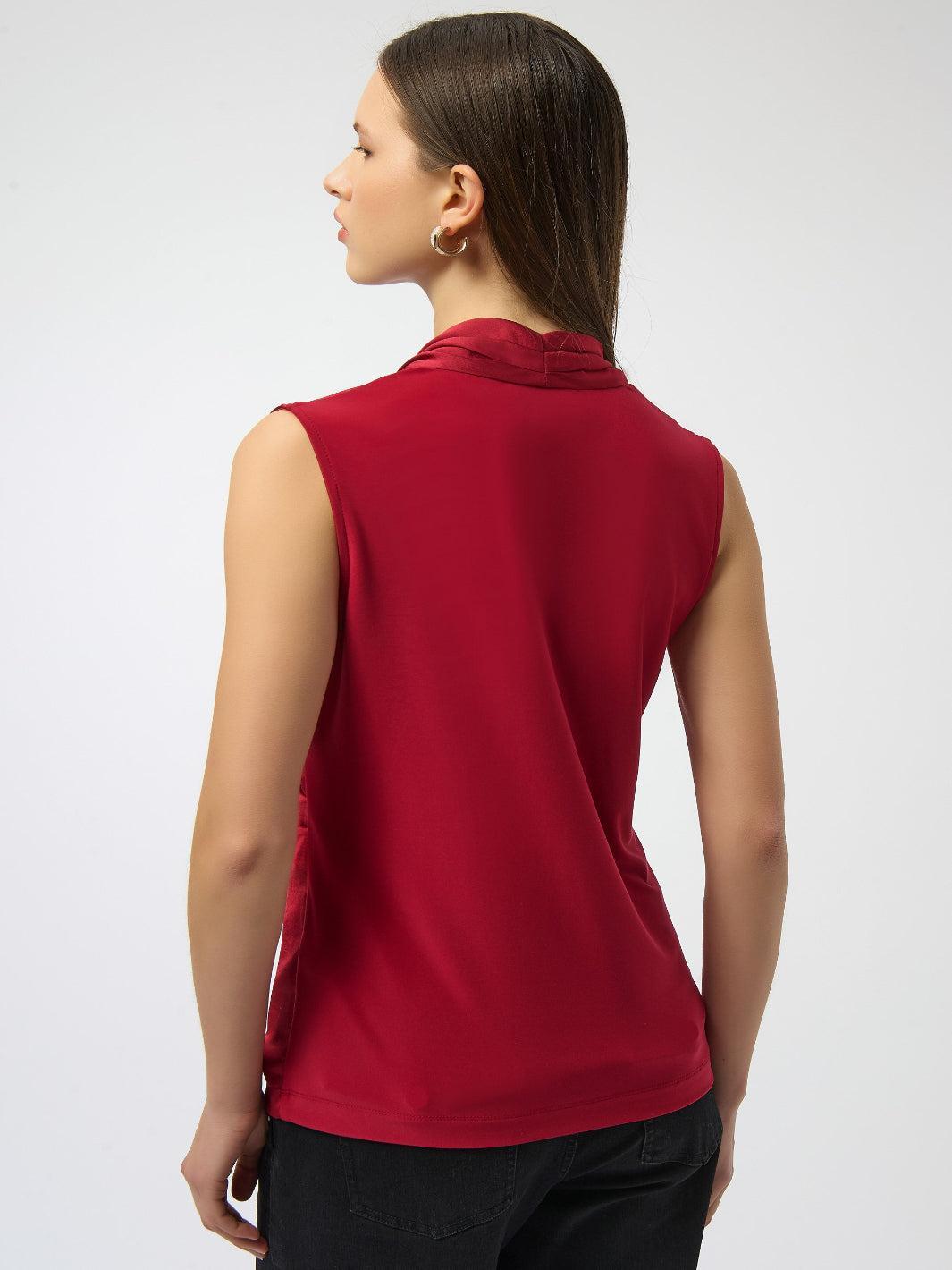 Woman wearing a red sleeveless top on a white background