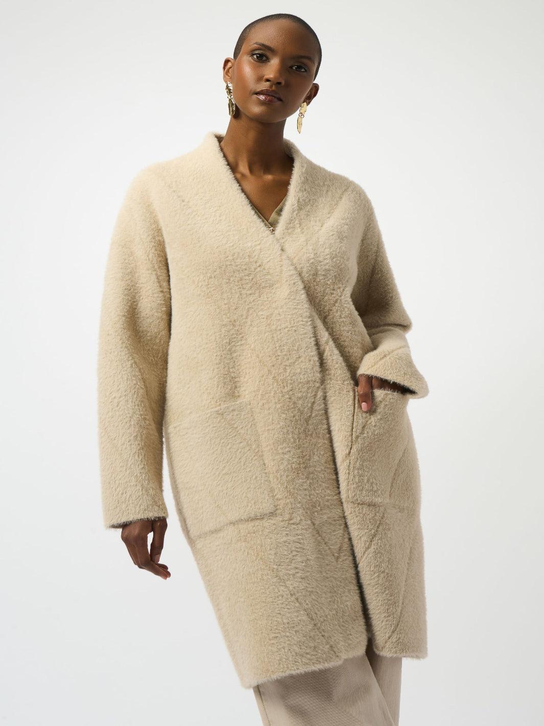 Woman wearing a beige cardigan on a white background