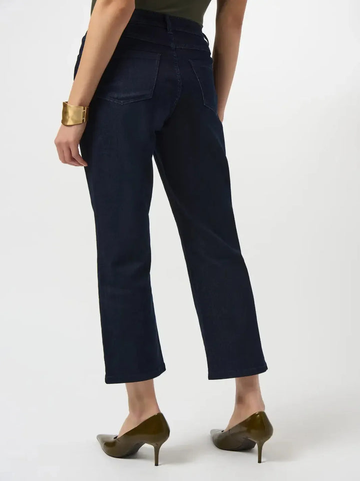 Navy blue pants worn by a person on a white background