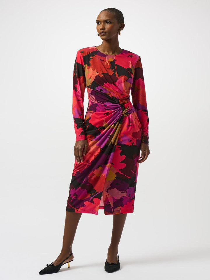 Woman wearing a colorful patterned dress on a white background