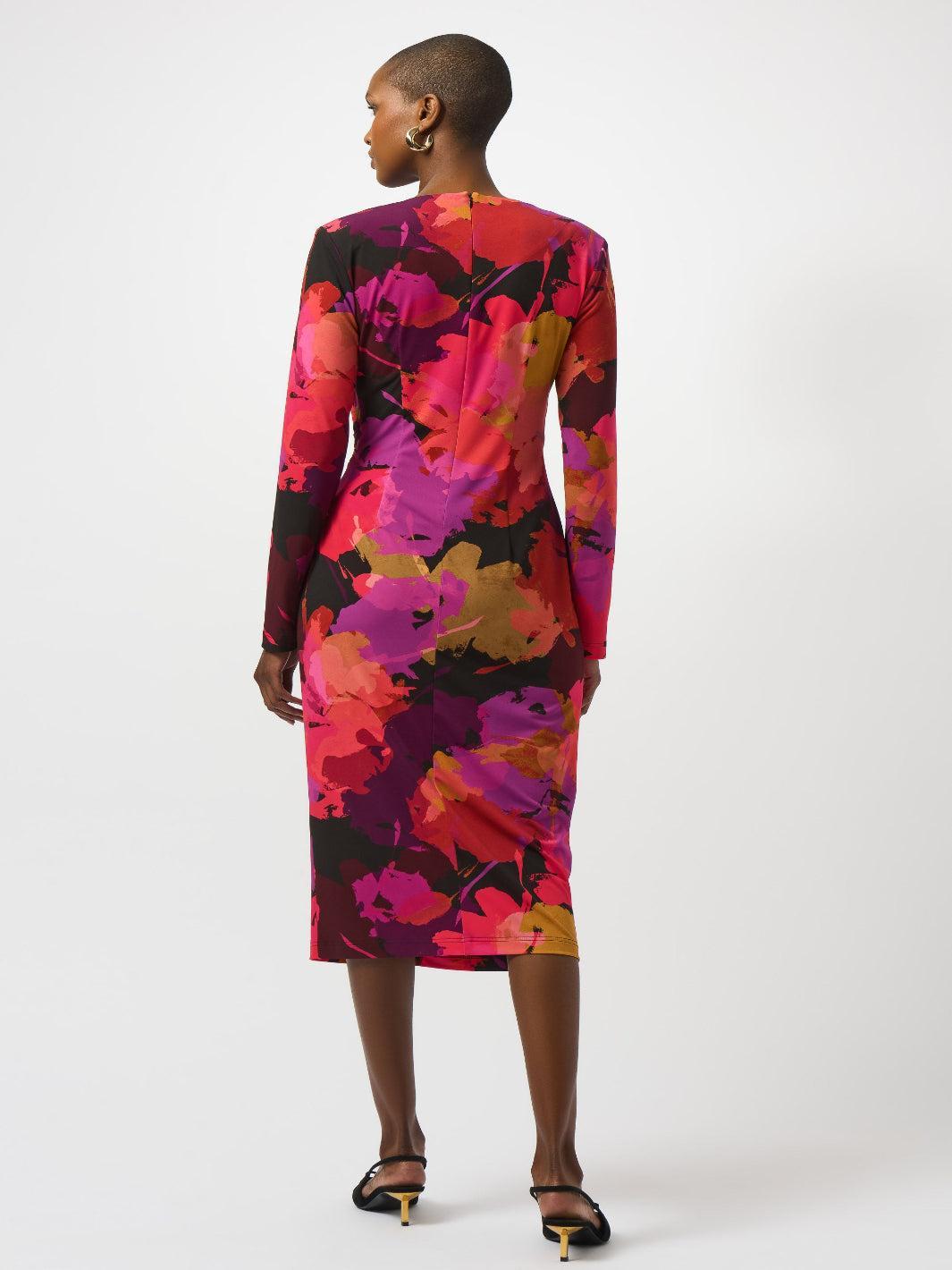 Woman wearing a colorful floral dress on a white background