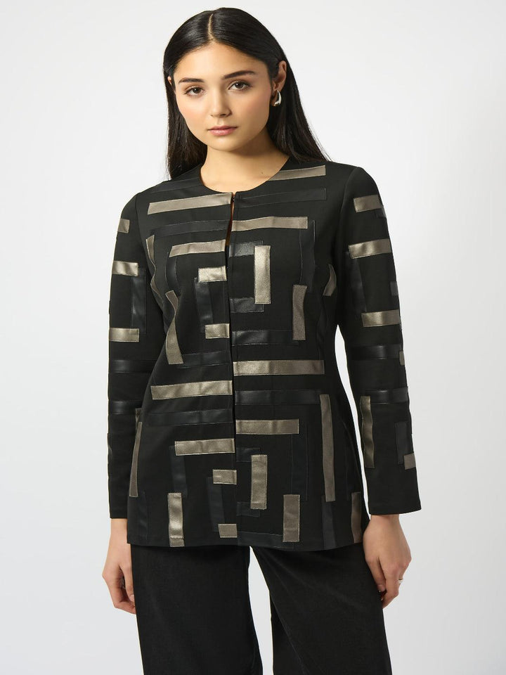 Woman wearing a black and gold patterned top on a white background
