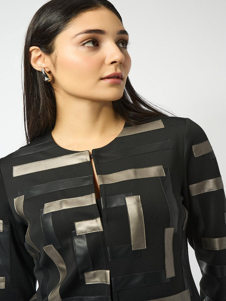 Woman wearing a black and silver jacket against a white background
