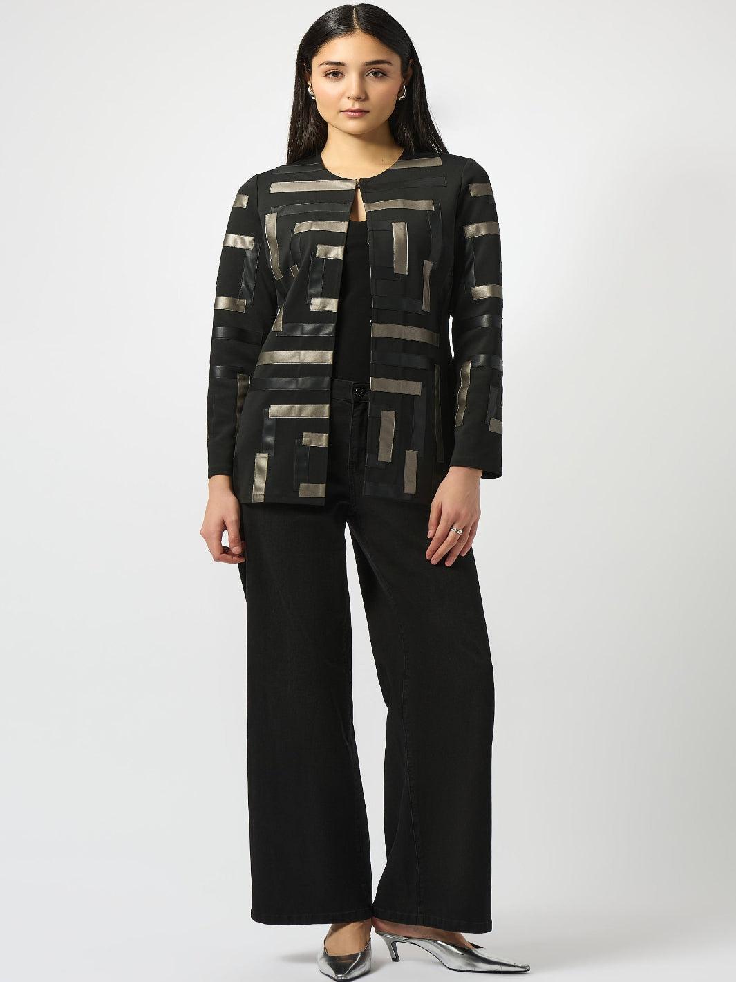 Woman wearing a black and gray patterned jacket with wide-leg pants on a white background