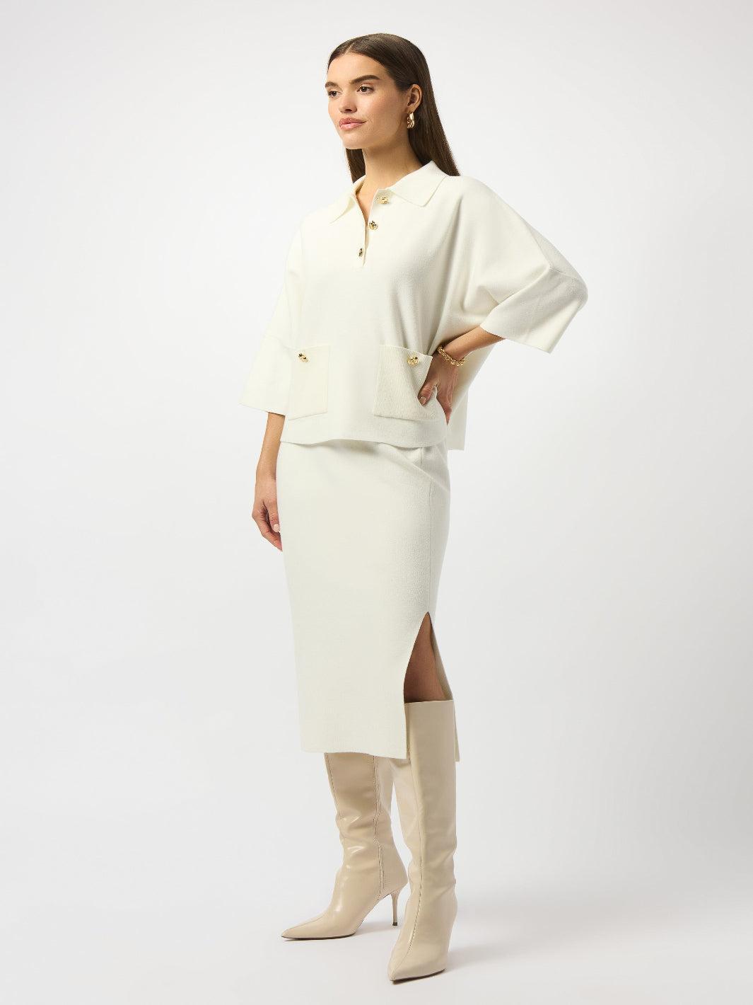 Woman wearing a white outfit with beige knee-high boots on a white background
