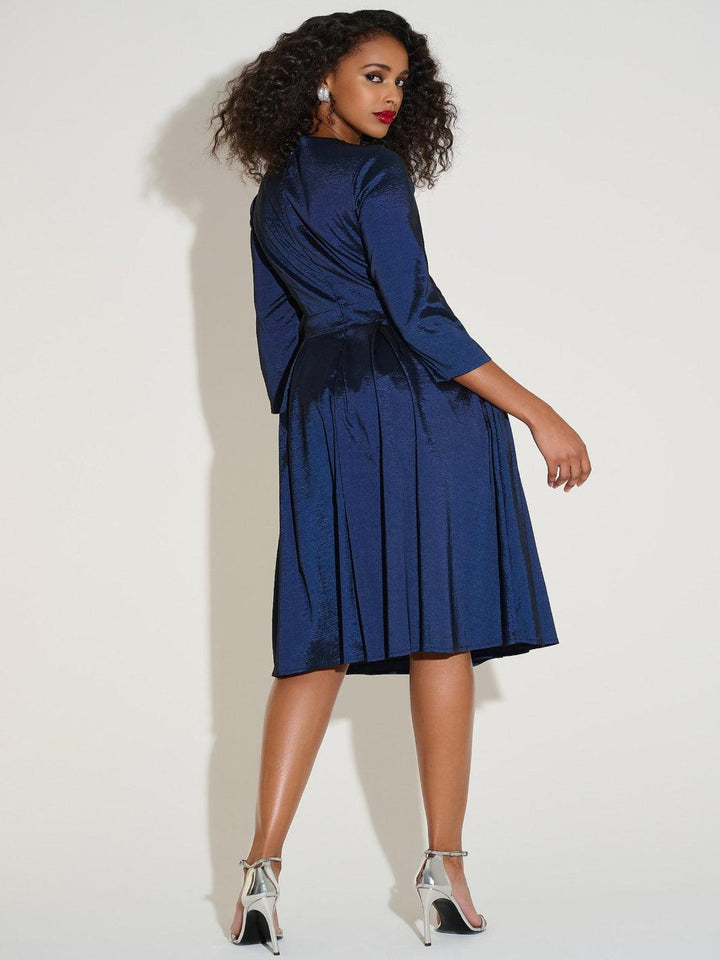 Woman wearing a blue dress against a white background