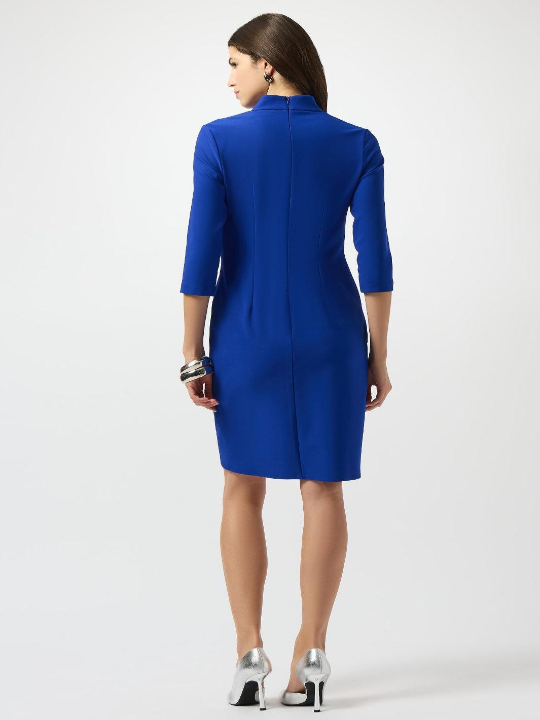 Woman wearing a blue dress on a white background