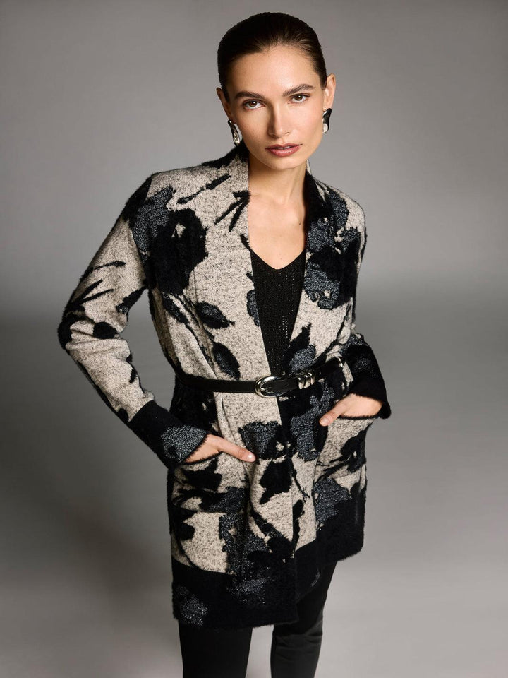 Woman wearing a patterned coat against a gray background