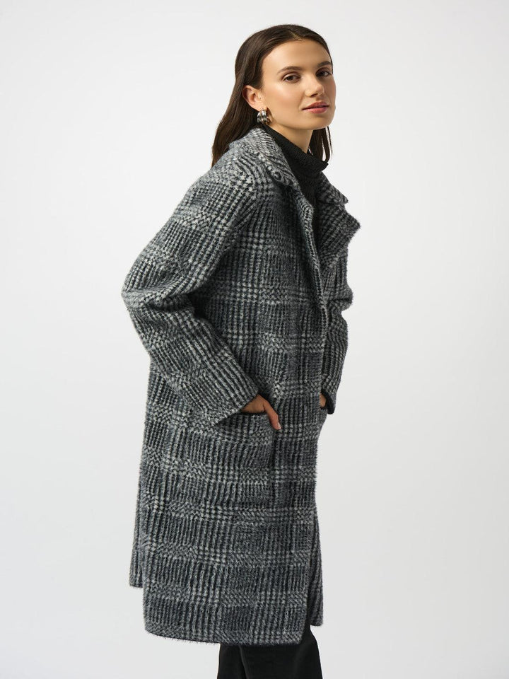 Woman wearing a checkered coat on a white background