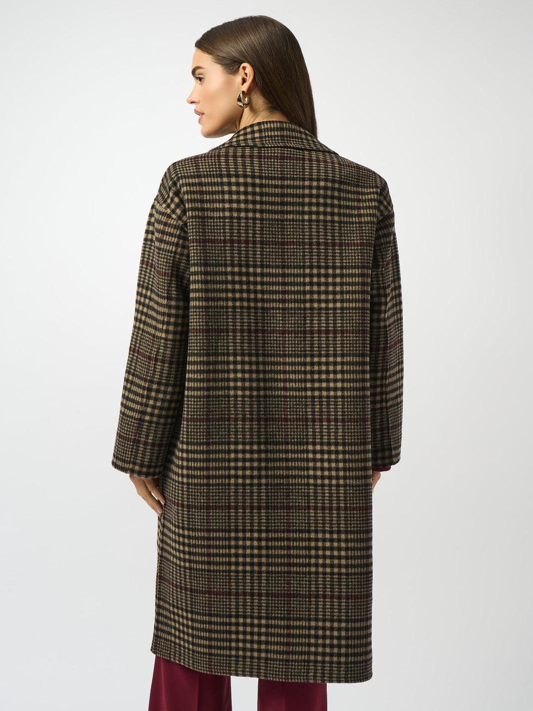 Person wearing a plaid coat on a white background