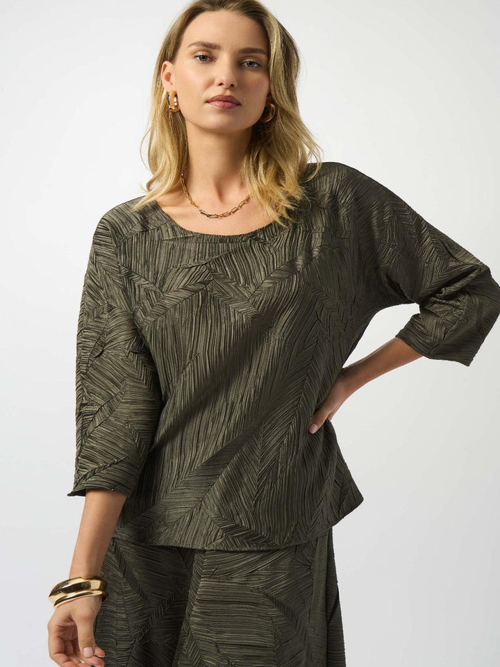 Woman wearing a green textured outfit on a white background