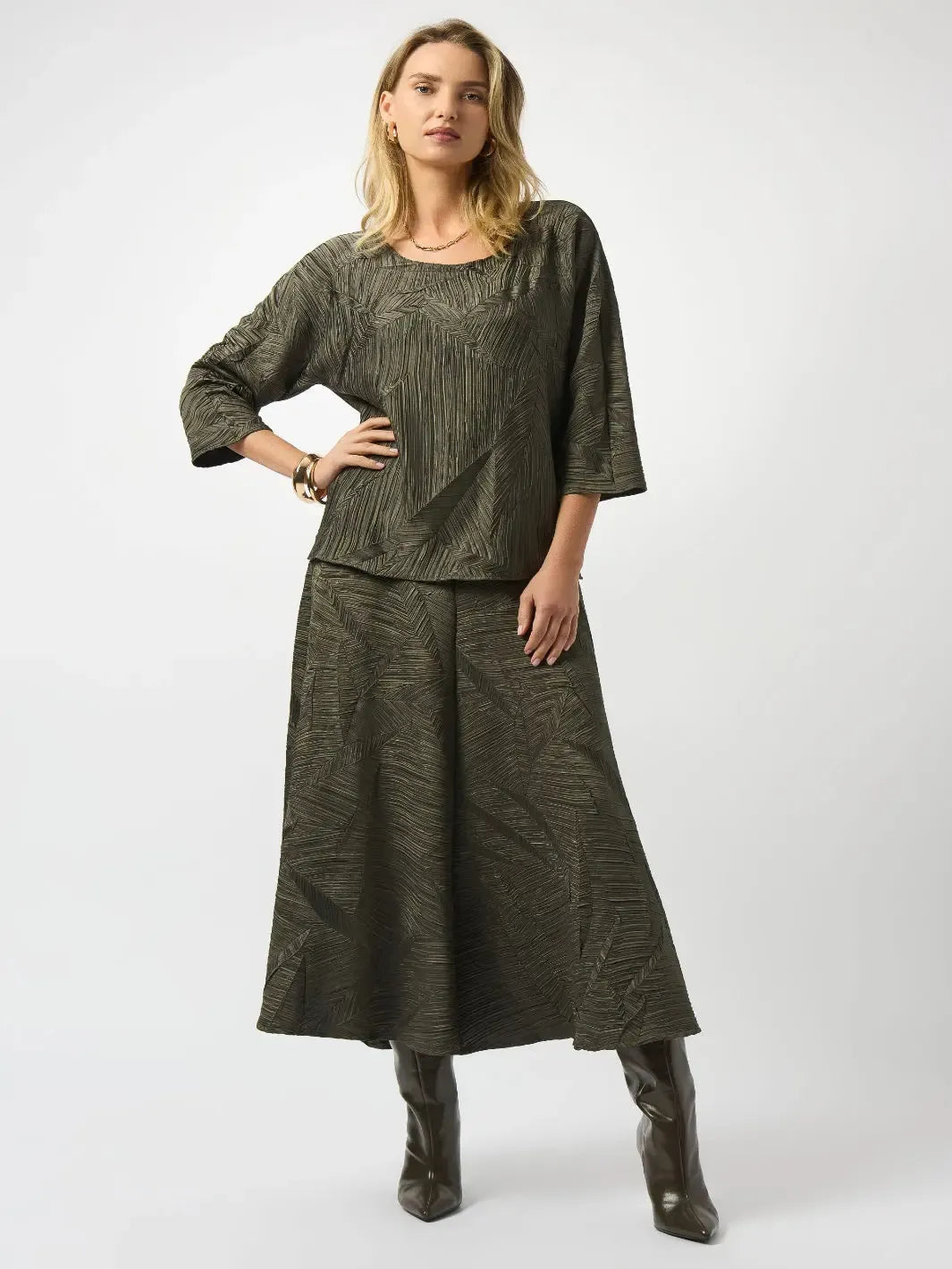 Woman wearing a green outfit with a top and skirt on a white background