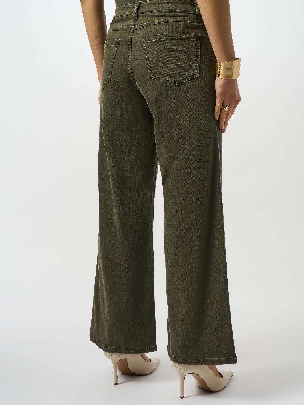 Person wearing olive green wide-leg pants on a white background