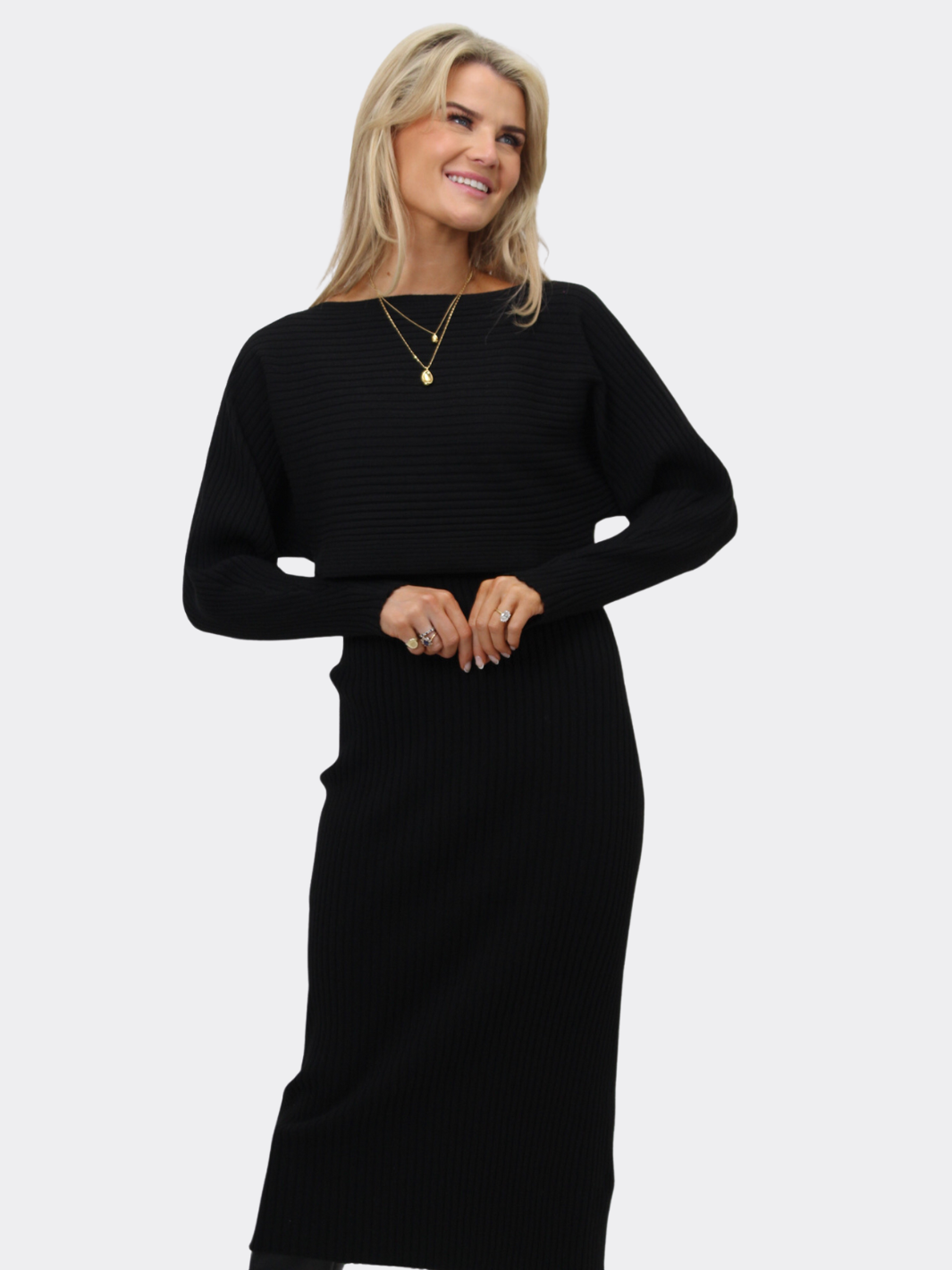 Woman wearing a black dress against a white background