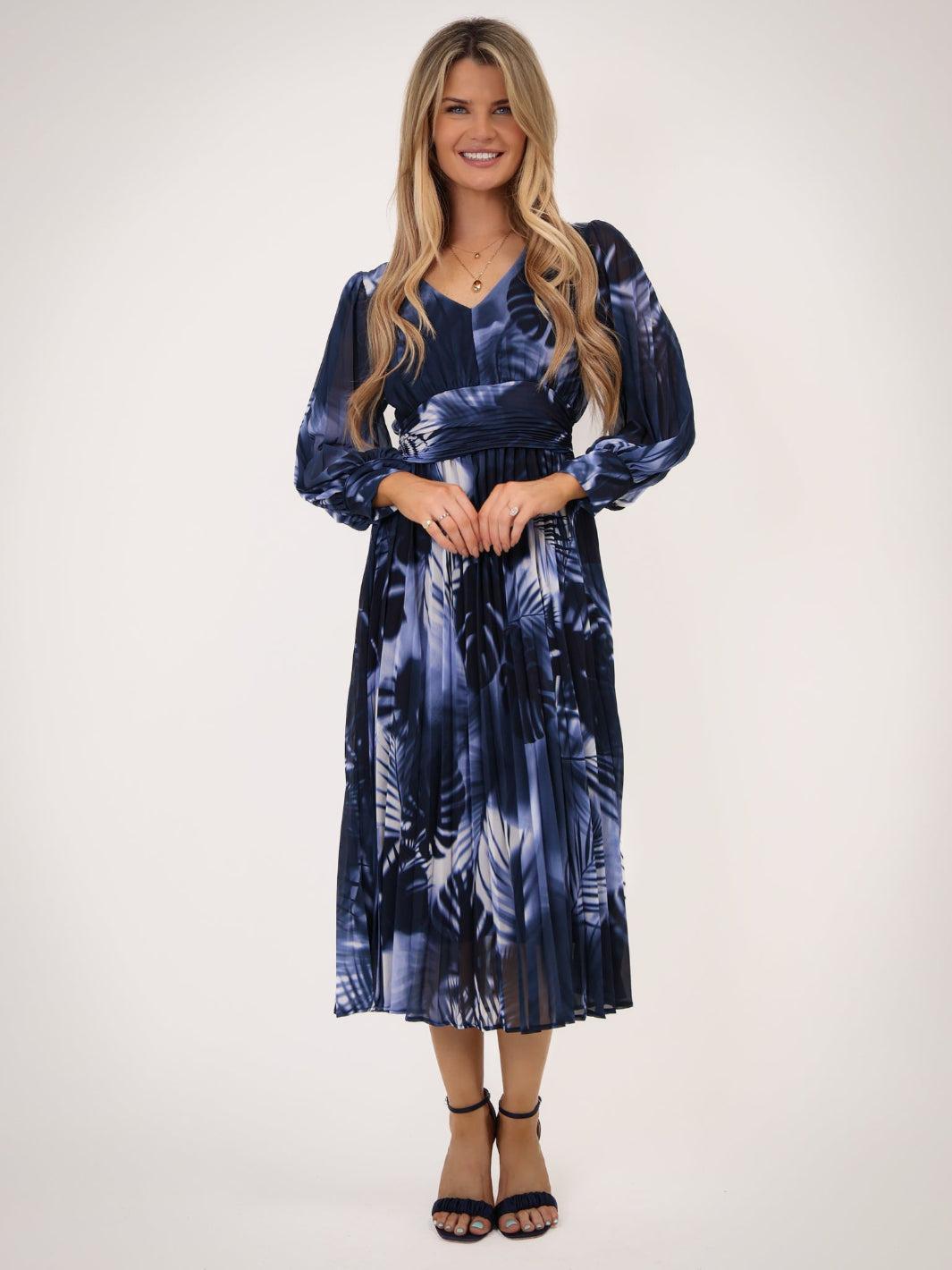 Woman wearing a blue tie-dye dress on a white background