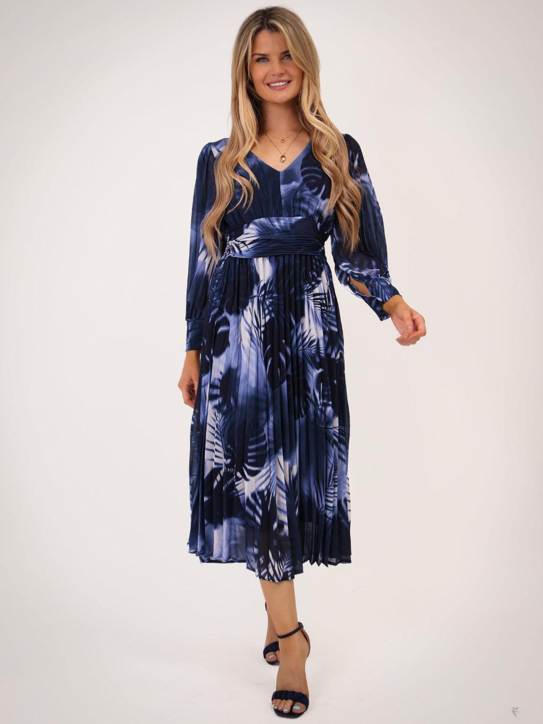 Woman wearing a blue and white patterned dress on a white background