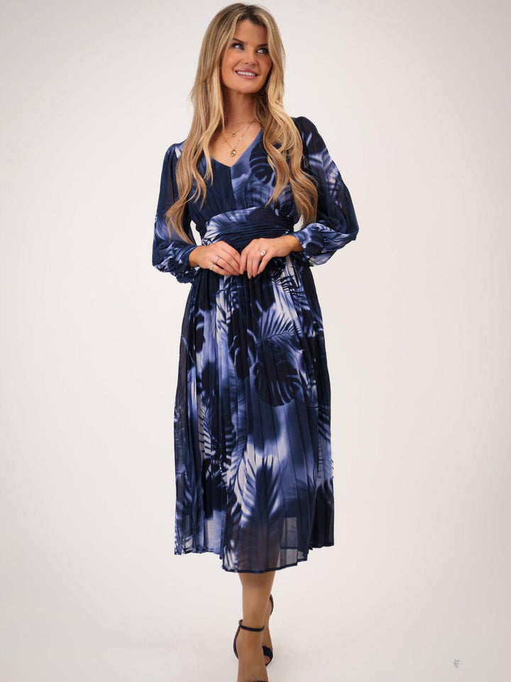 Woman wearing a blue tie-dye dress on a white background