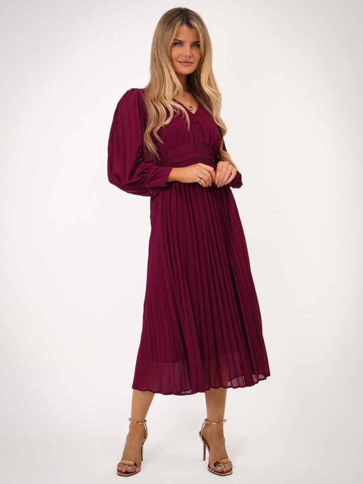 Woman wearing a burgundy dress on a white background