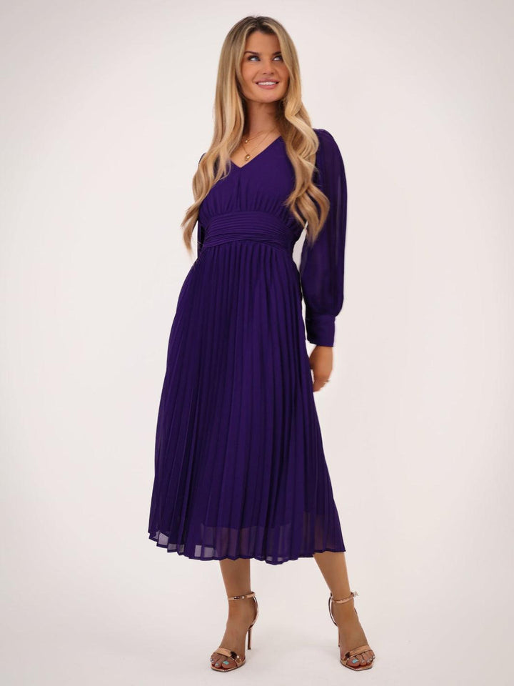 Woman wearing a purple dress on a white background