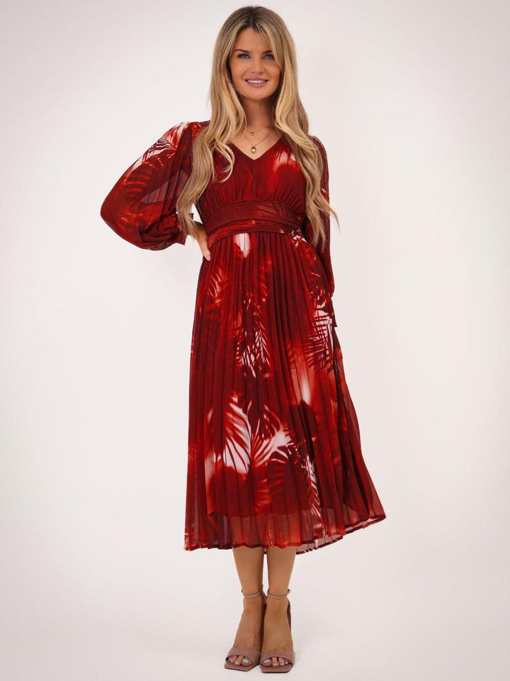 Woman wearing a red metallic dress on a white background