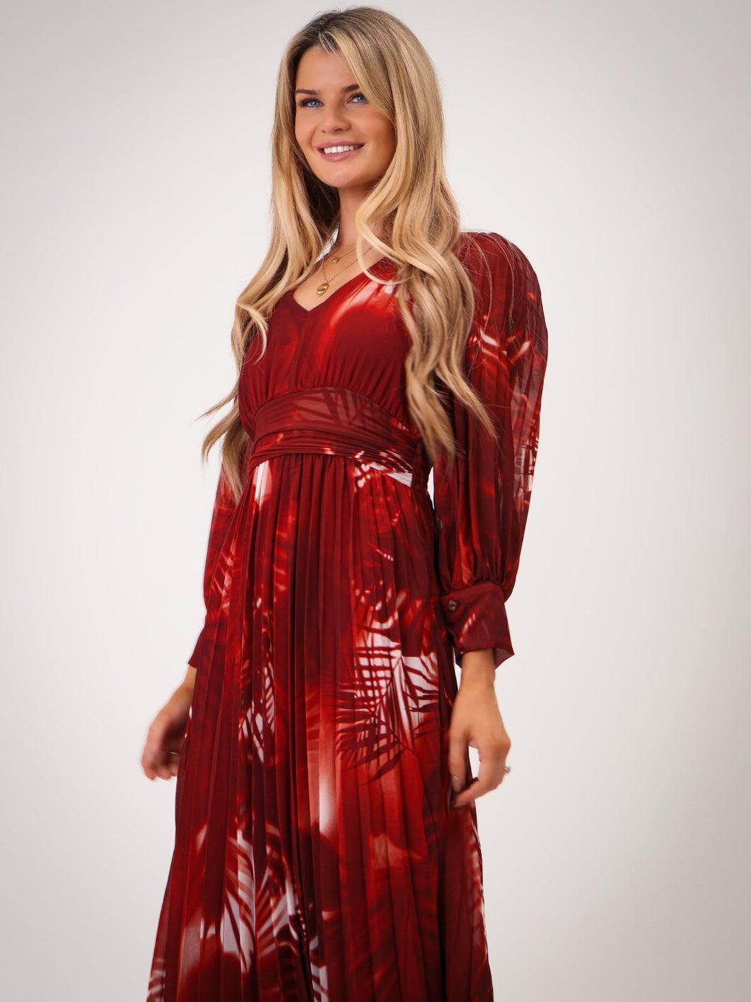 Woman wearing a shiny red dress against a plain background