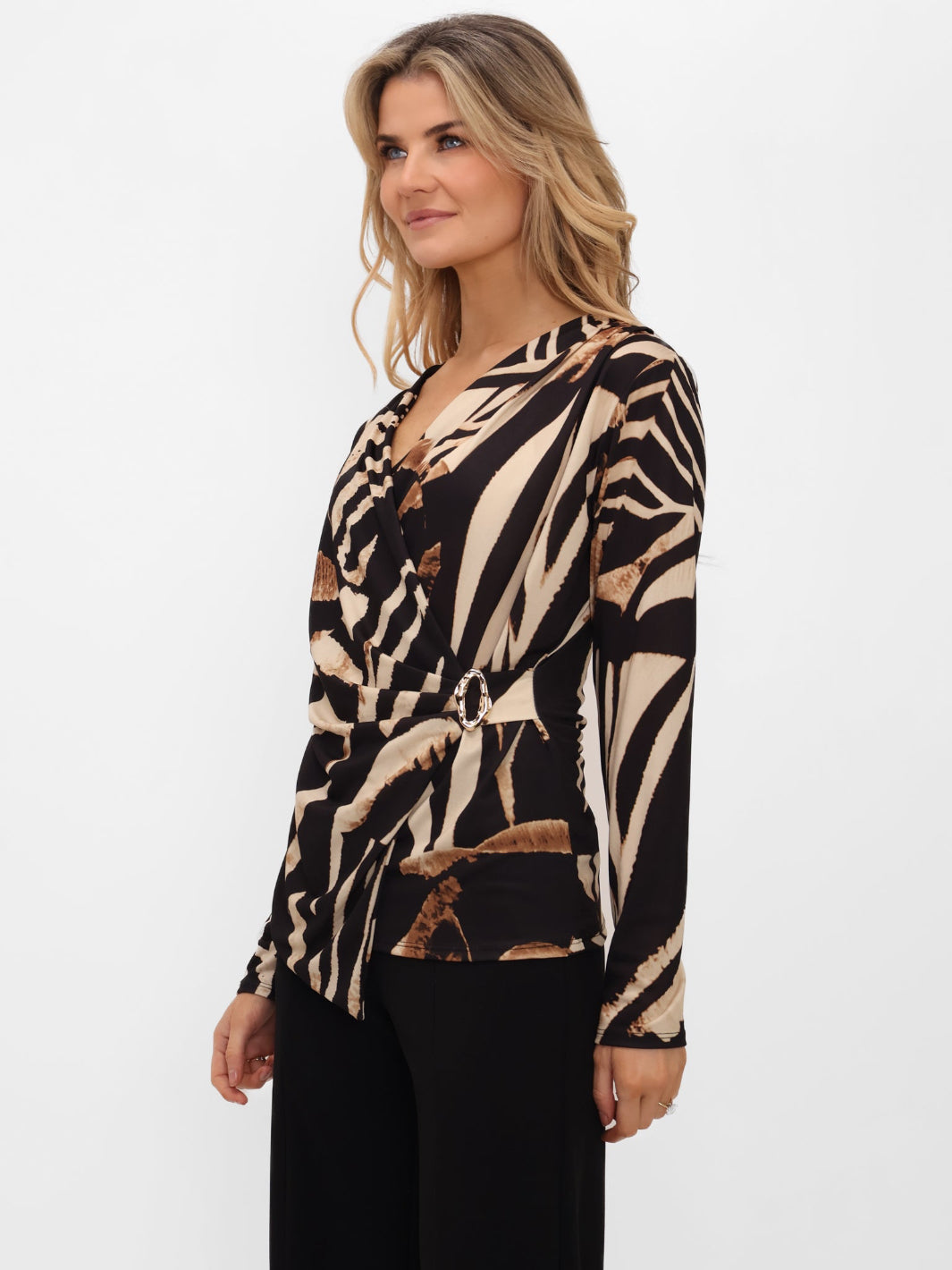Woman wearing a zebra print top on a white background