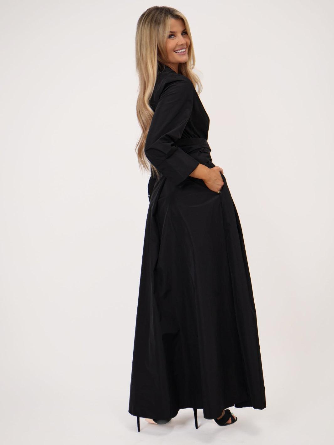 Woman wearing a black dress on a white background