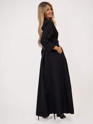 Woman wearing a black dress on a white background