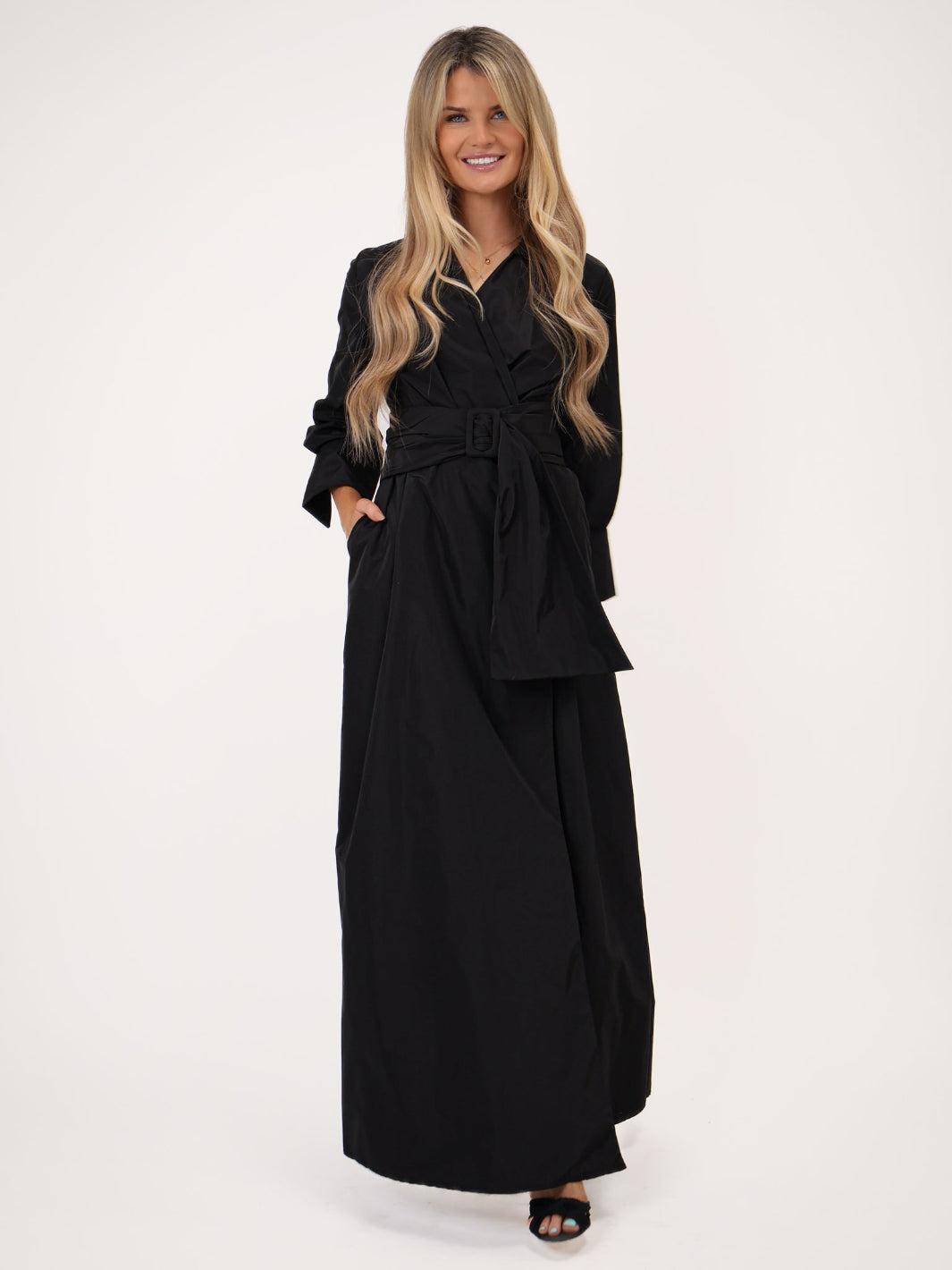 Woman wearing a black outfit on a white background