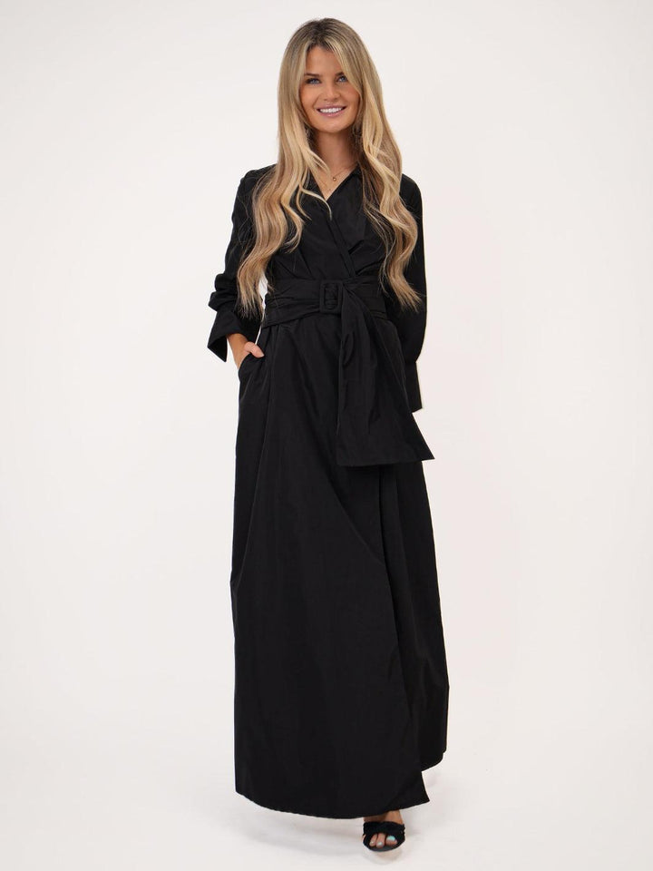 Woman wearing a black outfit on a white background