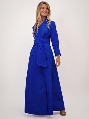 Woman wearing a blue dress with a belt on a white background
