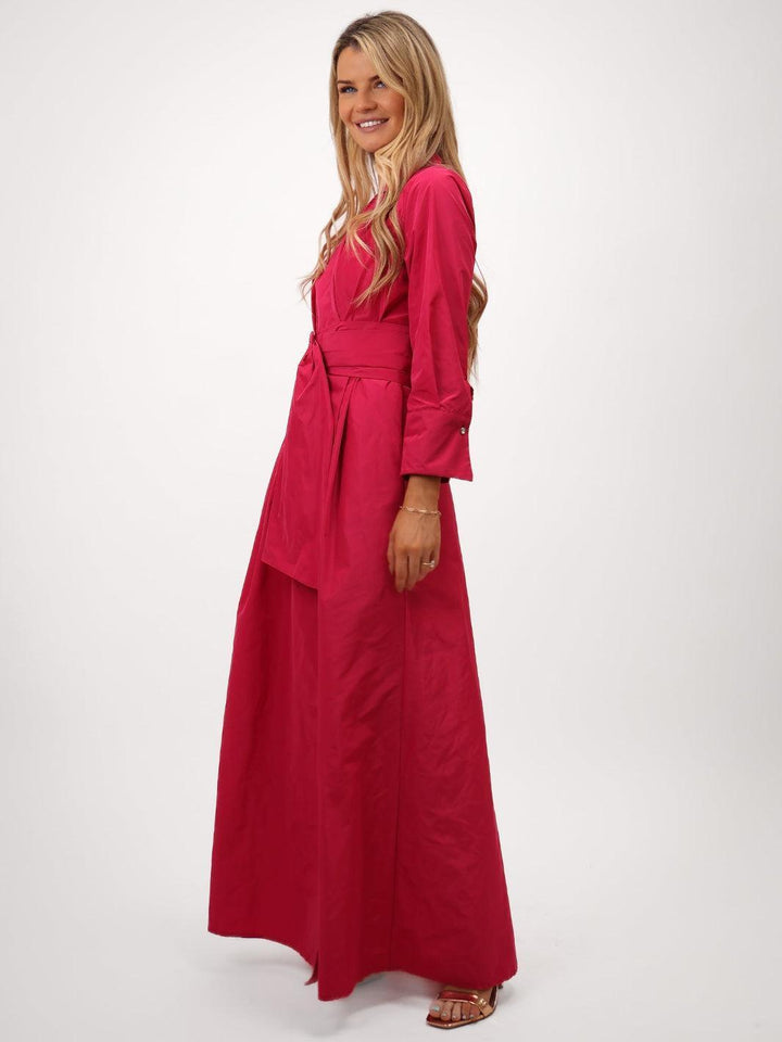 Woman wearing a long red dress on a white background