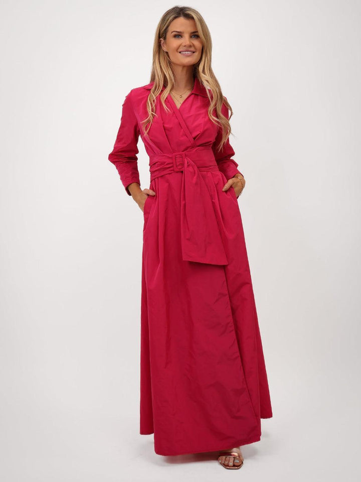 Woman wearing a long red dress on a white background